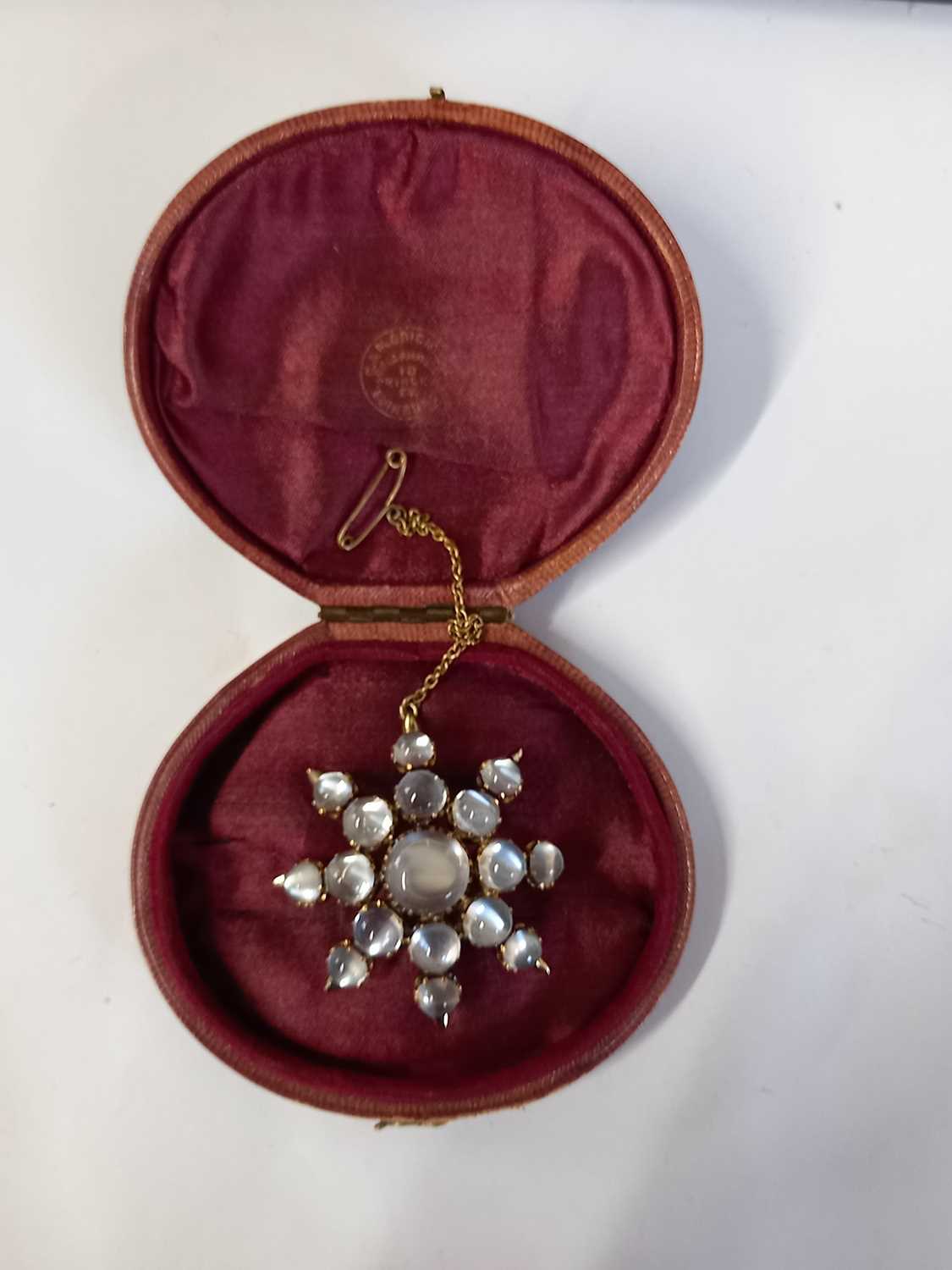 A moonstone 'star' brooch, the star shape comprised of graduated round moonstone cabochons, all claw - Image 6 of 7