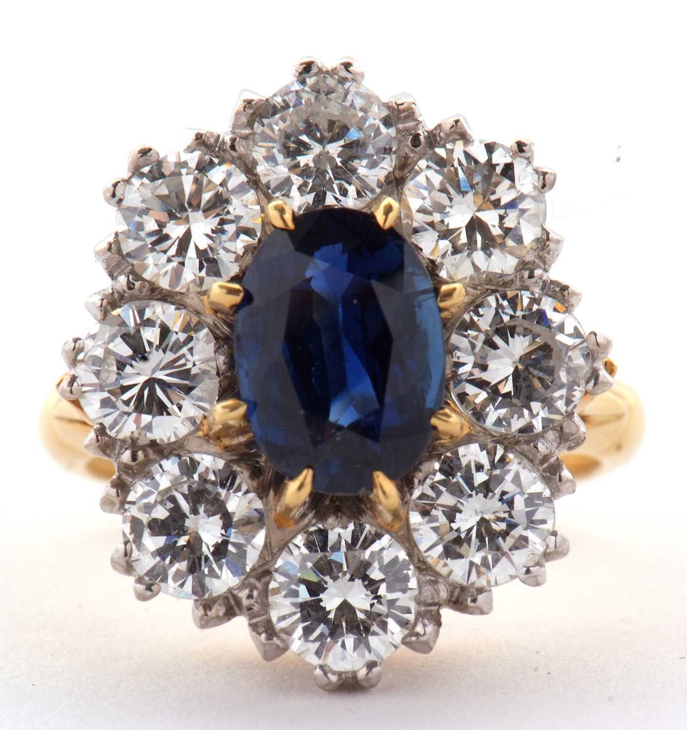 A sapphire and diamond cluster ring, the central claw oval sapphire, approx. 8.8 x 5.8 x 4.3mm, - Image 2 of 11