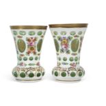 A pair of Bohemian style vases, the white flashed ground decorated with floral sprays,