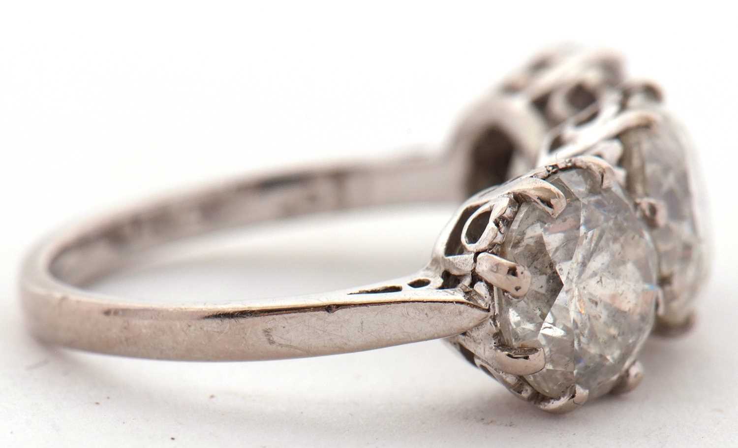 A three stone diamond ring, the three slightly graudated round brilliant cut diamonds, approx. 6. - Image 6 of 11