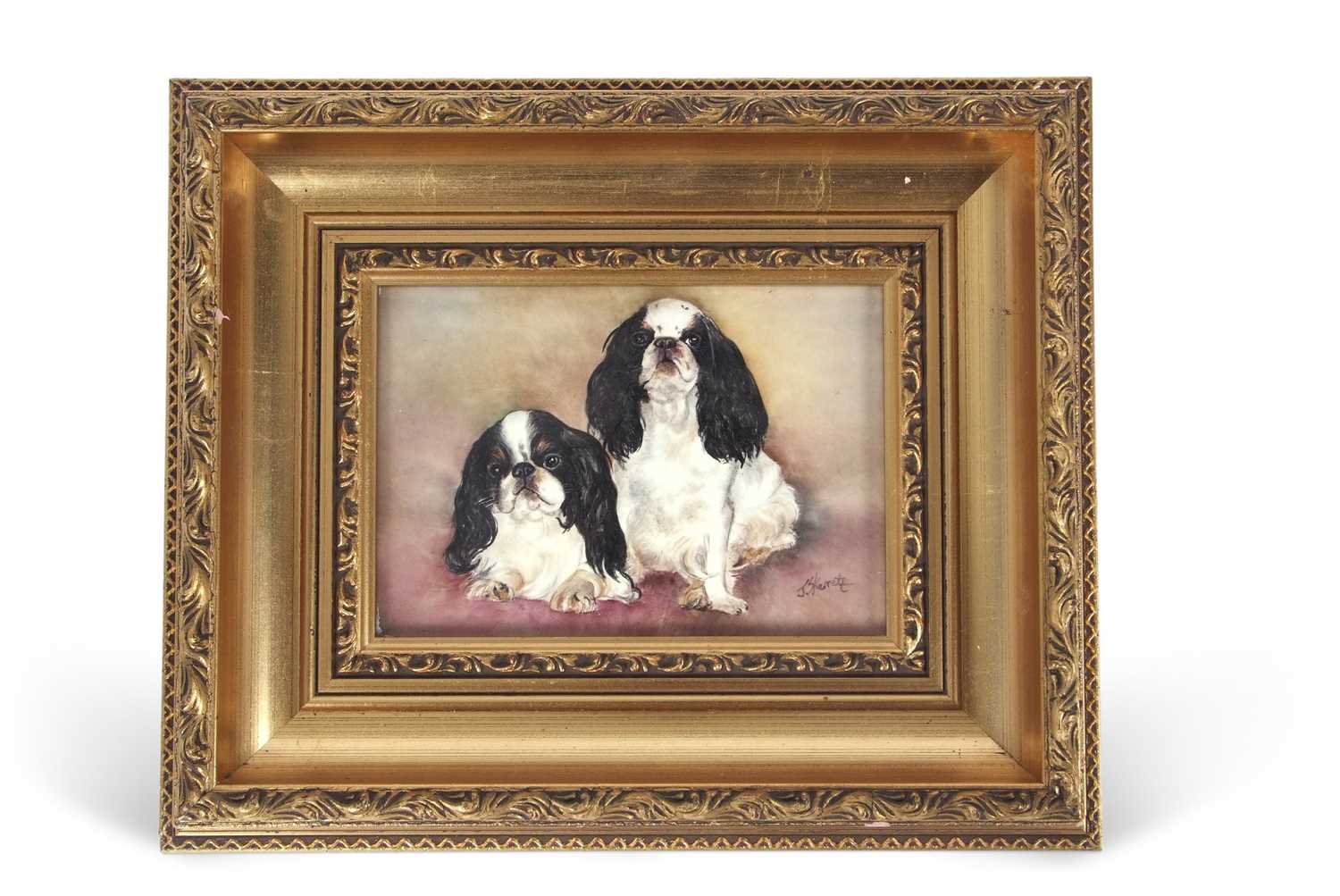 A gilt framed porcelain plaque of Pekingese dogs one of silken thread entitled Thimble and the other