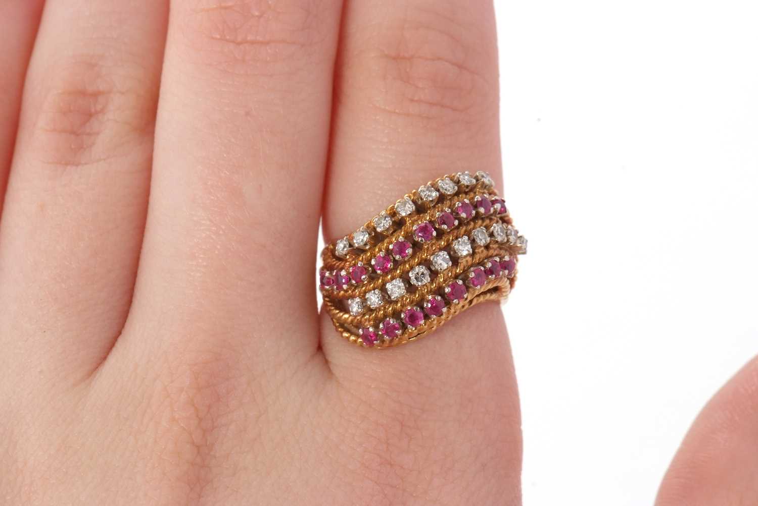 An 18ct diamond and ruby ring, set with four alternating curving diagonal rows of rubies and - Image 8 of 10