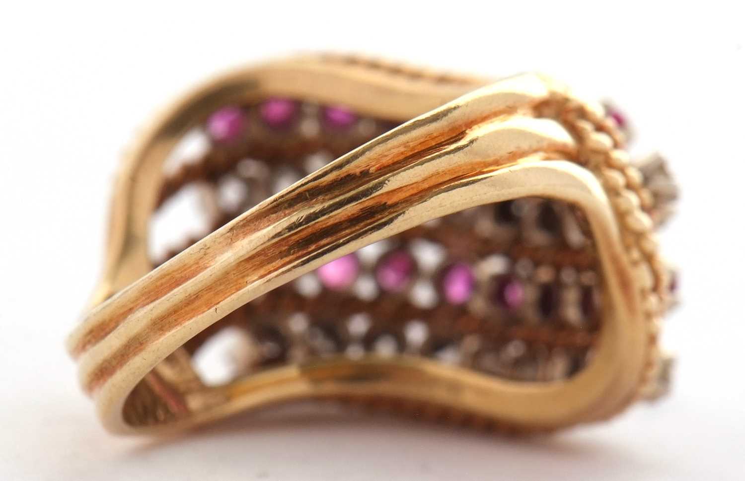 An 18ct diamond and ruby ring, set with four alternating curving diagonal rows of rubies and - Image 9 of 10
