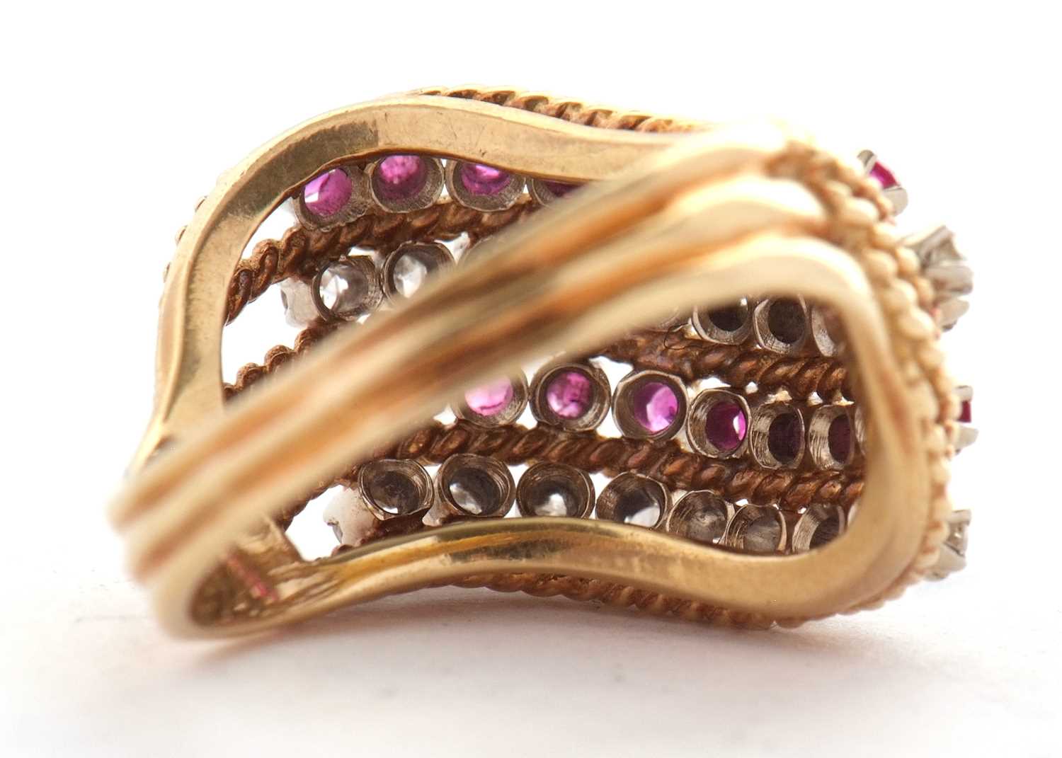 An 18ct diamond and ruby ring, set with four alternating curving diagonal rows of rubies and - Image 10 of 10