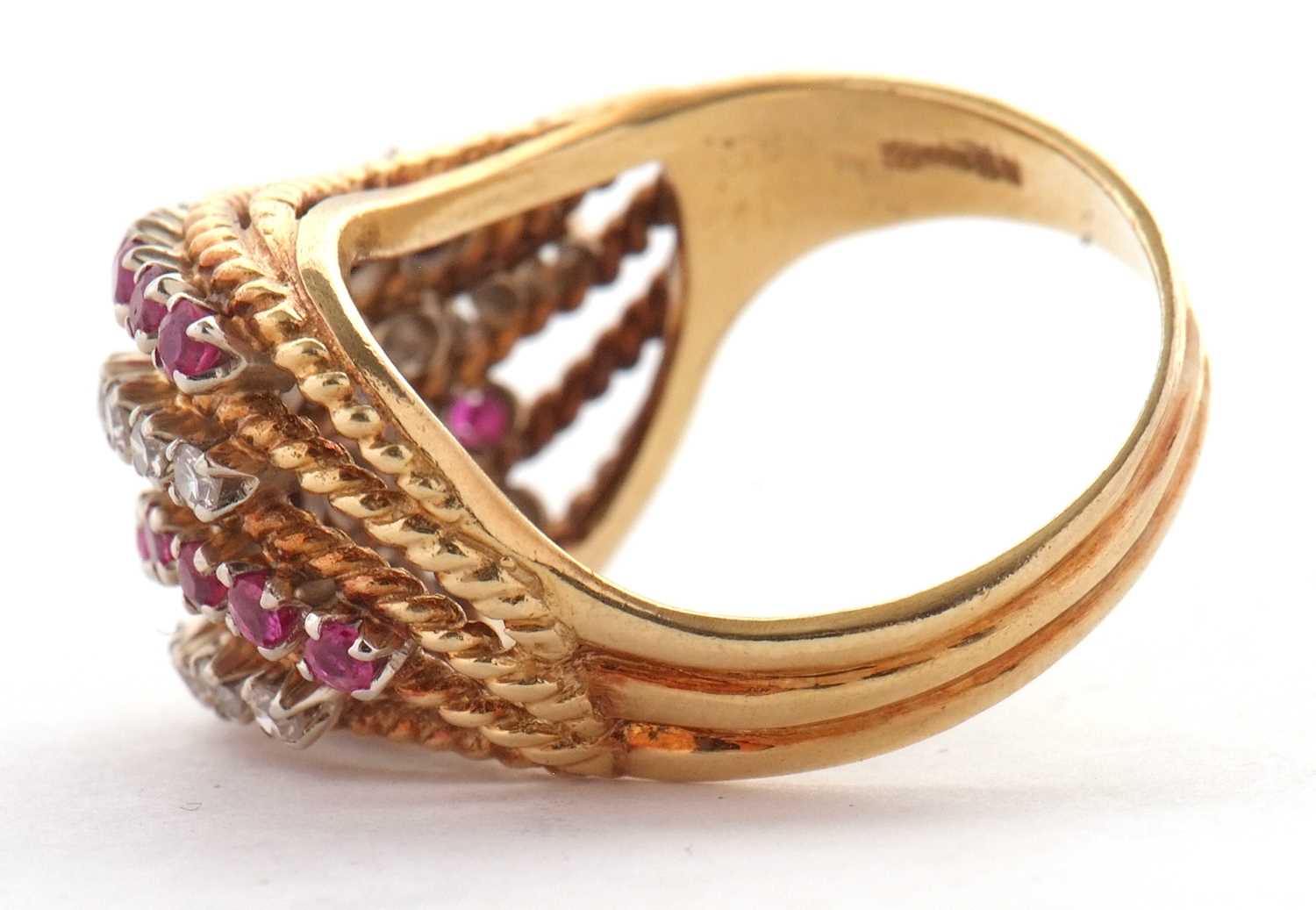 An 18ct diamond and ruby ring, set with four alternating curving diagonal rows of rubies and - Image 4 of 10