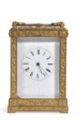 A 19th Century French carriage clock with white enamel dial, a brass framed case with scrolled