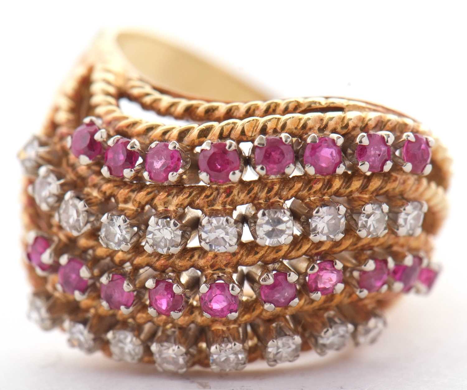 An 18ct diamond and ruby ring, set with four alternating curving diagonal rows of rubies and - Image 3 of 10