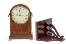 McCabe - A Georgian mahogany cased bracket clock set in an arched case inlaid decoration, brass side