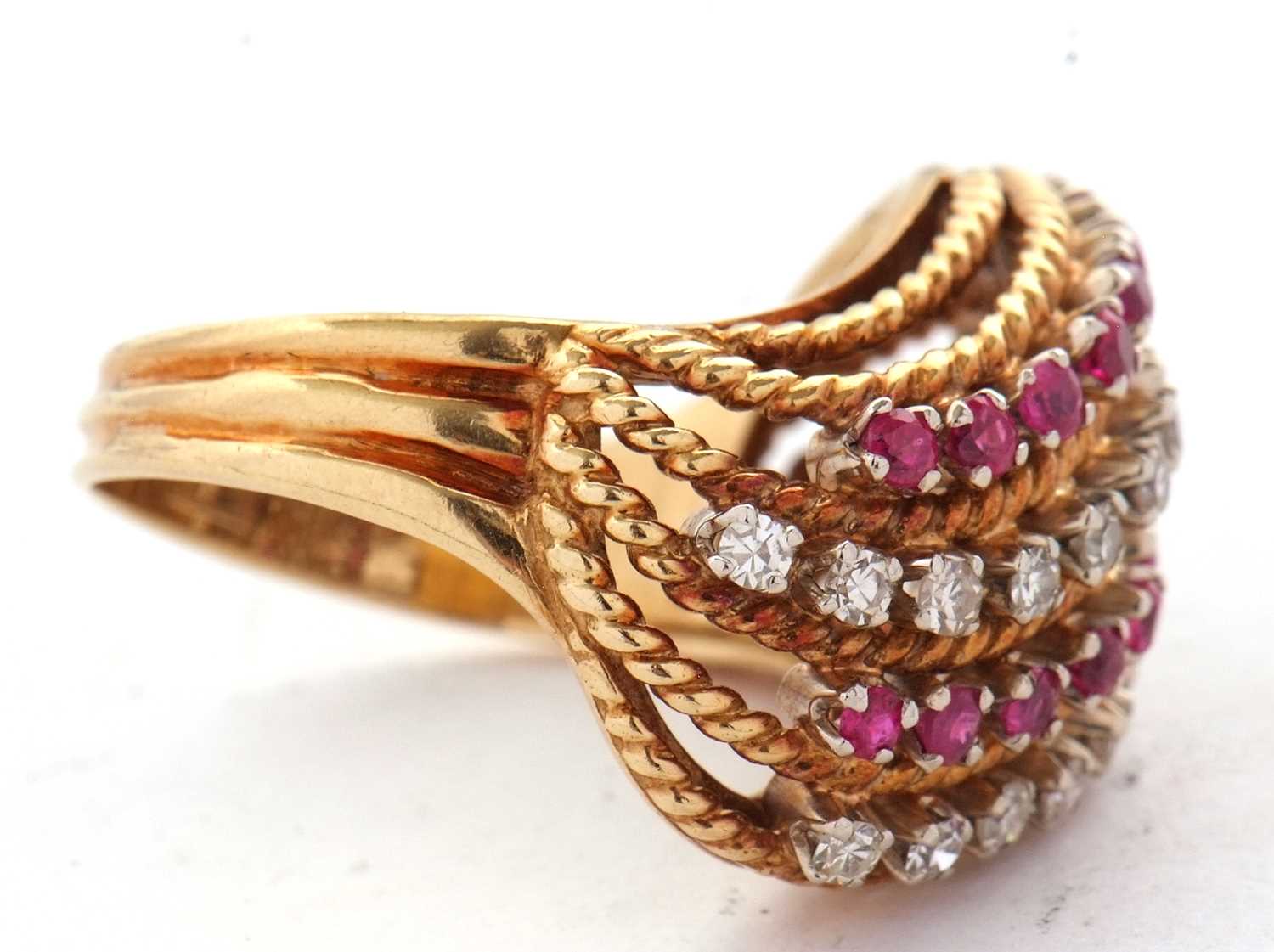 An 18ct diamond and ruby ring, set with four alternating curving diagonal rows of rubies and - Image 5 of 10