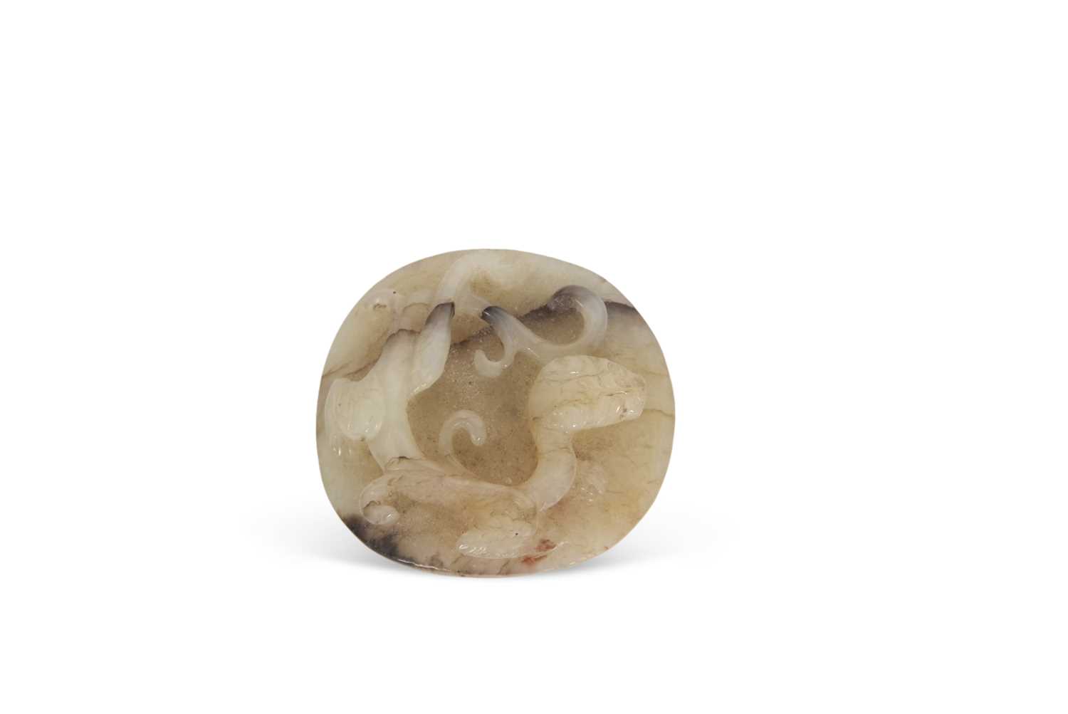 A jade pendant with dragon carving with brown occlusions, 4cm diameter