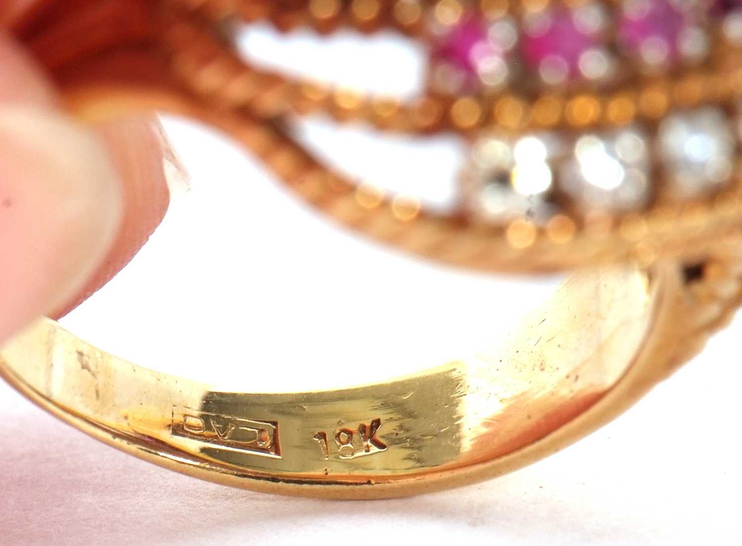 An 18ct diamond and ruby ring, set with four alternating curving diagonal rows of rubies and - Image 6 of 10