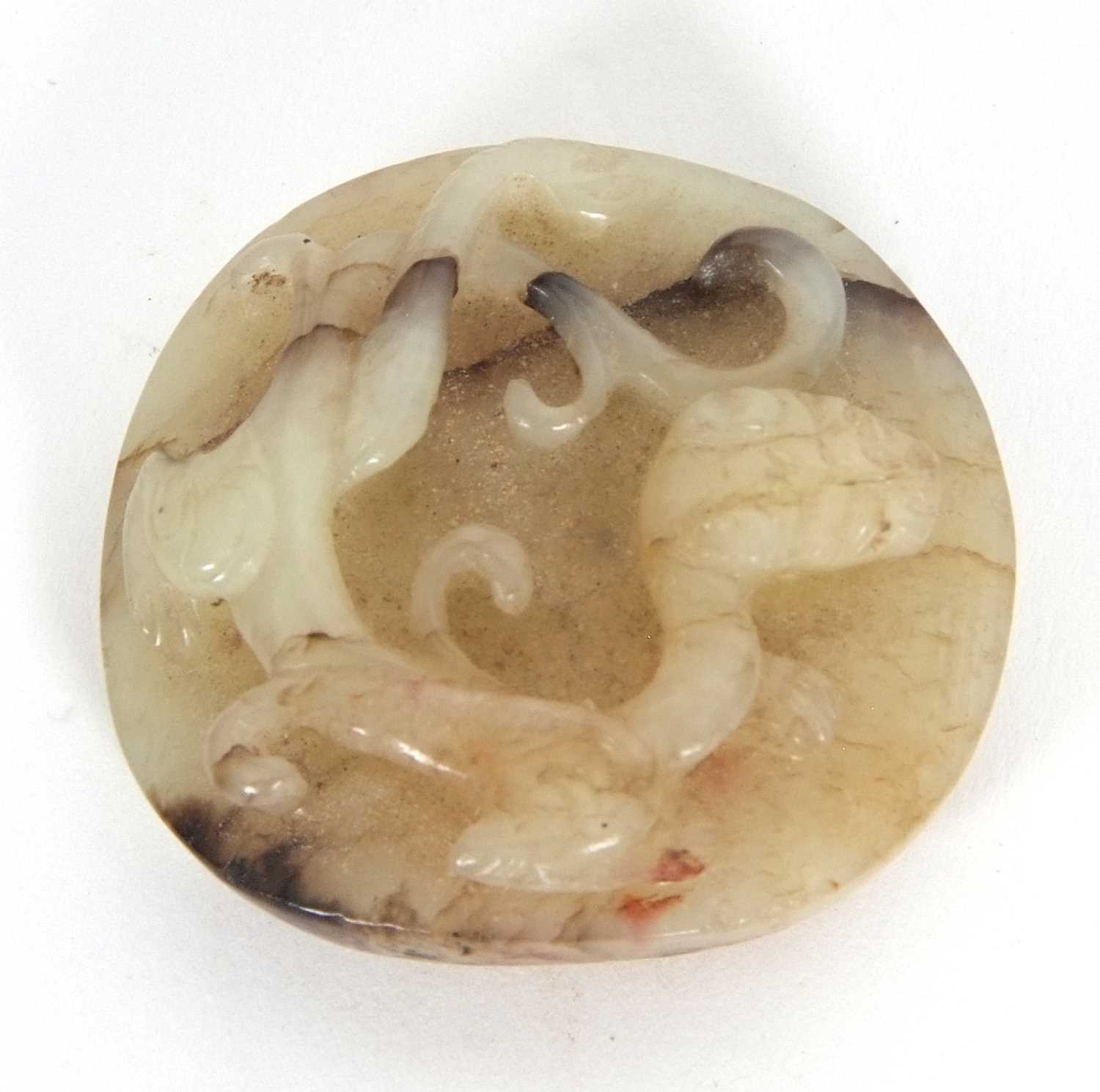 A jade pendant with dragon carving with brown occlusions, 4cm diameter - Image 2 of 6