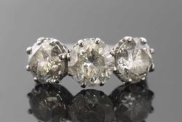 A three stone diamond ring, the three slightly graduated round brilliant cut diamonds, approx. 6.
