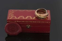 An 18ct Cartier trinity ring, the white, yellow and rose gold bands hallmarked London 1973,