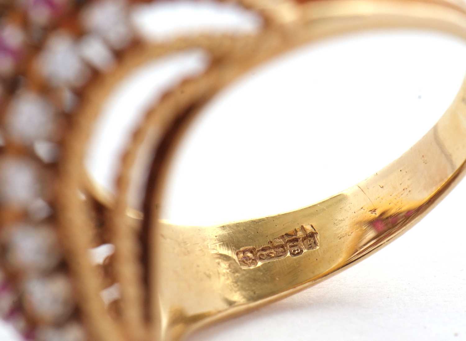 An 18ct diamond and ruby ring, set with four alternating curving diagonal rows of rubies and - Image 7 of 10