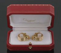 A pair of Cartier 18ct diamond set earclips, the ridged bands, 7.5mm wide, set with a single round