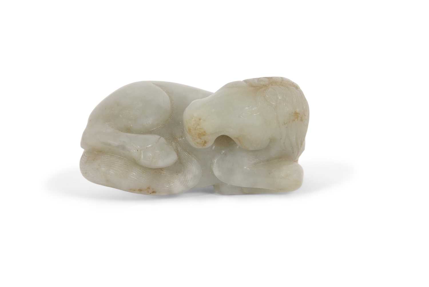 A jade carving of a horse with some brown occlusions, 6cm long
