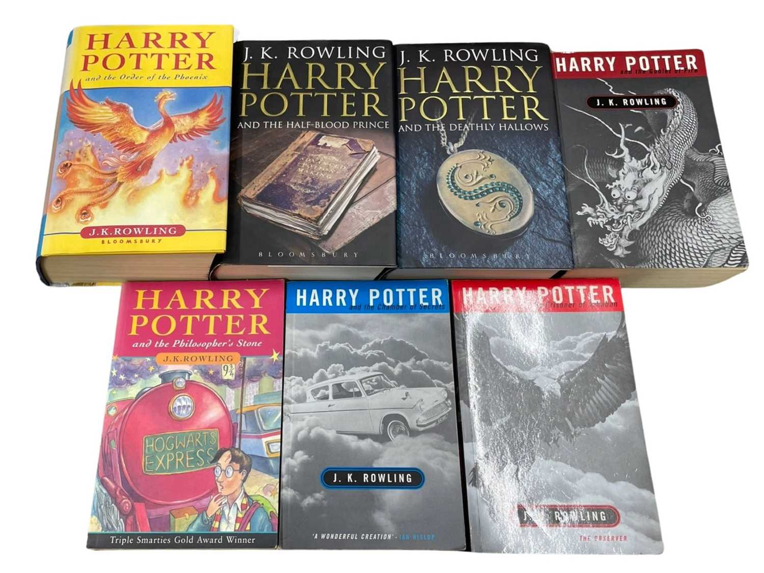A collection of Harry Potter books, mixed editions and covers.
