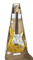 An Aria electric guitar, bearing the signatures of various 1960s bands in black ink, to include: -