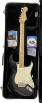 An American Fender Stratocaster electric guitar, circa 2001 in black, with black hardcase and