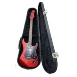 A Hondo Fame Series 760 electric guitar, in black lined hardcase. Scratching across body and