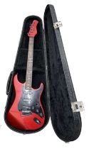 A Hondo Fame Series 760 electric guitar, in black lined hardcase. Scratching across body and