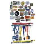 A collection of vintage British Racing patches and pin badges, together with a collection of British