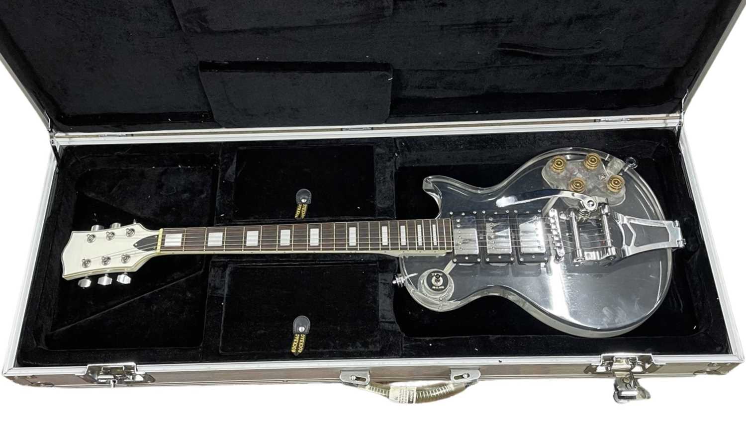 An acrylic clear-body Les Paul-shaped electric guitar, with no makers mark, within generic silver