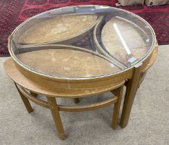 A Nathan Trinity nest of tables with central glass topped table and three further small teak pull