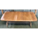 An Ercol light elm coffee table of rectangular form with base shelf, 105cm wide