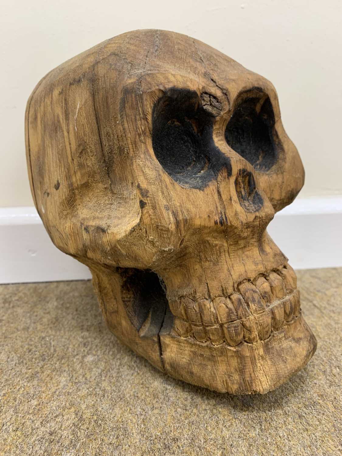 Attributed to David Chedgey (British, b.1940), Carved wood skull sculpture, 12x20cm approx.