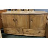 An Ercol light elm sideboard with three doors over two drawers, 130cm wide