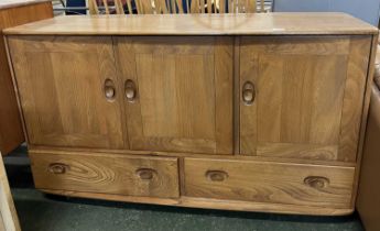 An Ercol light elm sideboard with three doors over two drawers, 130cm wide