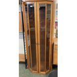A modern teak lounge display cabinet, the top section with two glazed doors over a base with