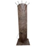 A modern combination coat and stick stand formed of textured iron of curved form with illuminated