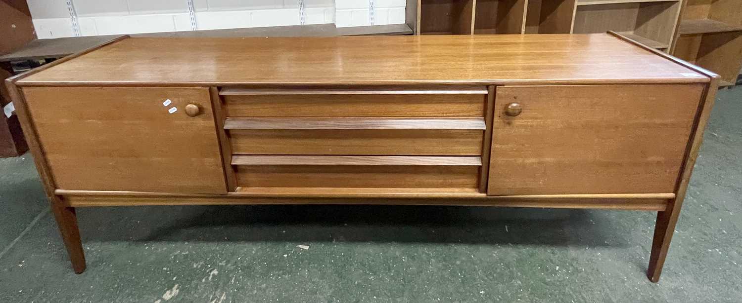 A mid Century teak sideboard with two end doors and three central drawers raised on tapering legs,