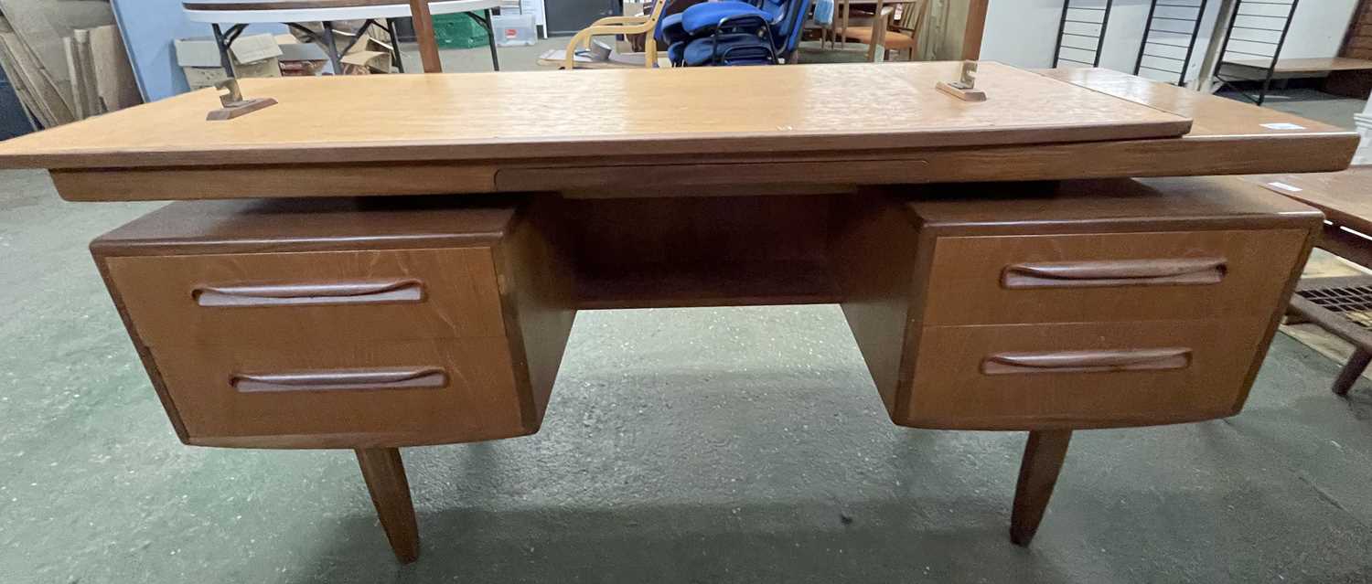 A mid Century teak dressing table, probably G-Plan with mirrored back over a base with four