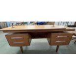 A mid Century teak dressing table, probably G-Plan with mirrored back over a base with four