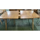 An Ercol light elm extending dining table raised on tapering legs, 150cm wide The table appears