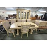 An extensive modern light wood dining room suite comprising an extending dining table with eight