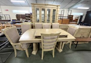 An extensive modern light wood dining room suite comprising an extending dining table with eight