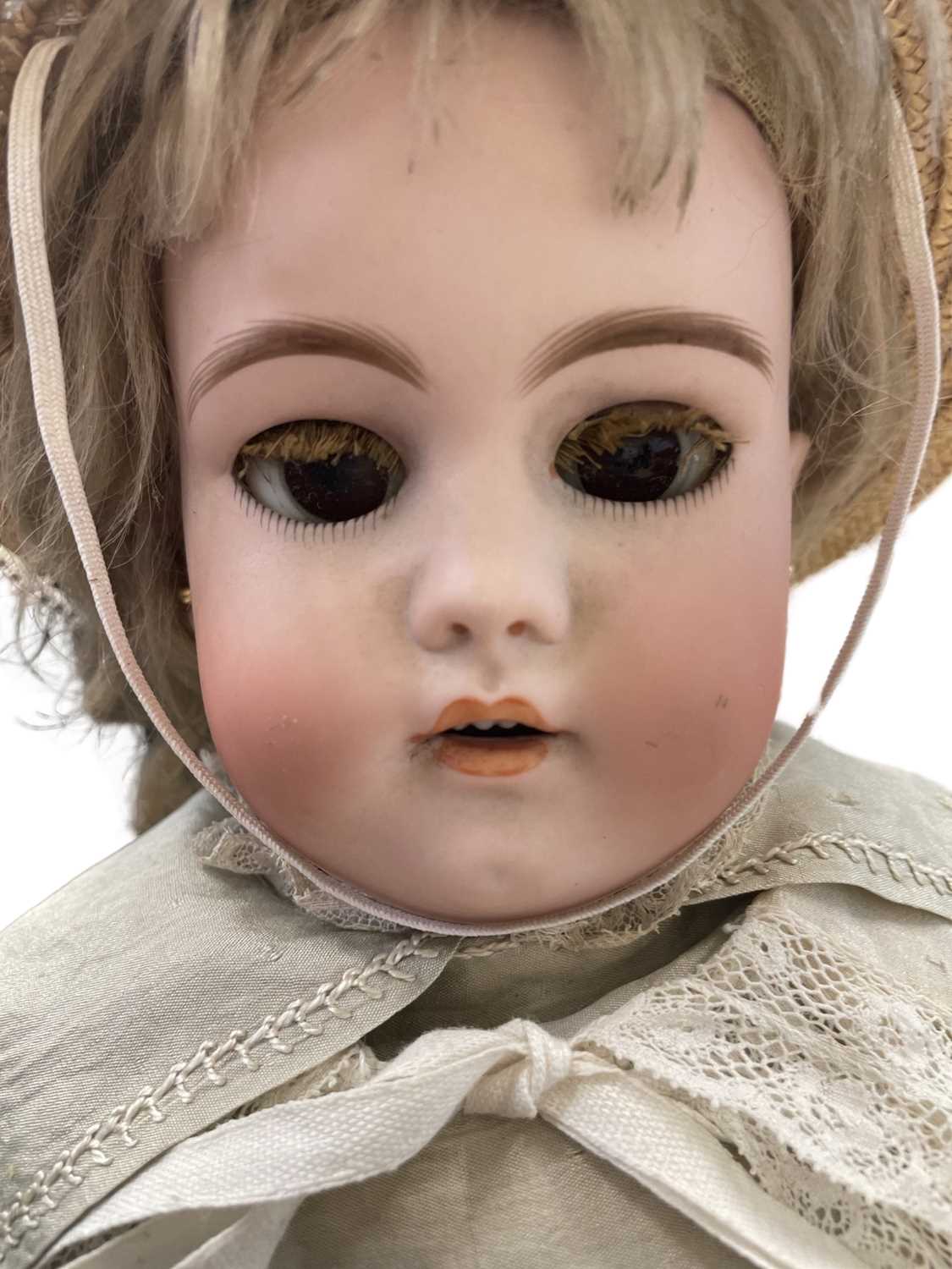 A Simon and Halbig bisque head doll, with blue eyes and teeth showing. Pierced ears with later - Bild 5 aus 6