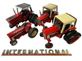 Four large scale die-cast model International tractors (2 repainted), together with an International