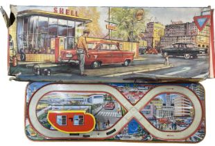 A vintage Welsotoys tinplate Shell garage and car track (losses and tears to box, missing car)
