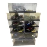 A collection of cased Quartzo racing car models
