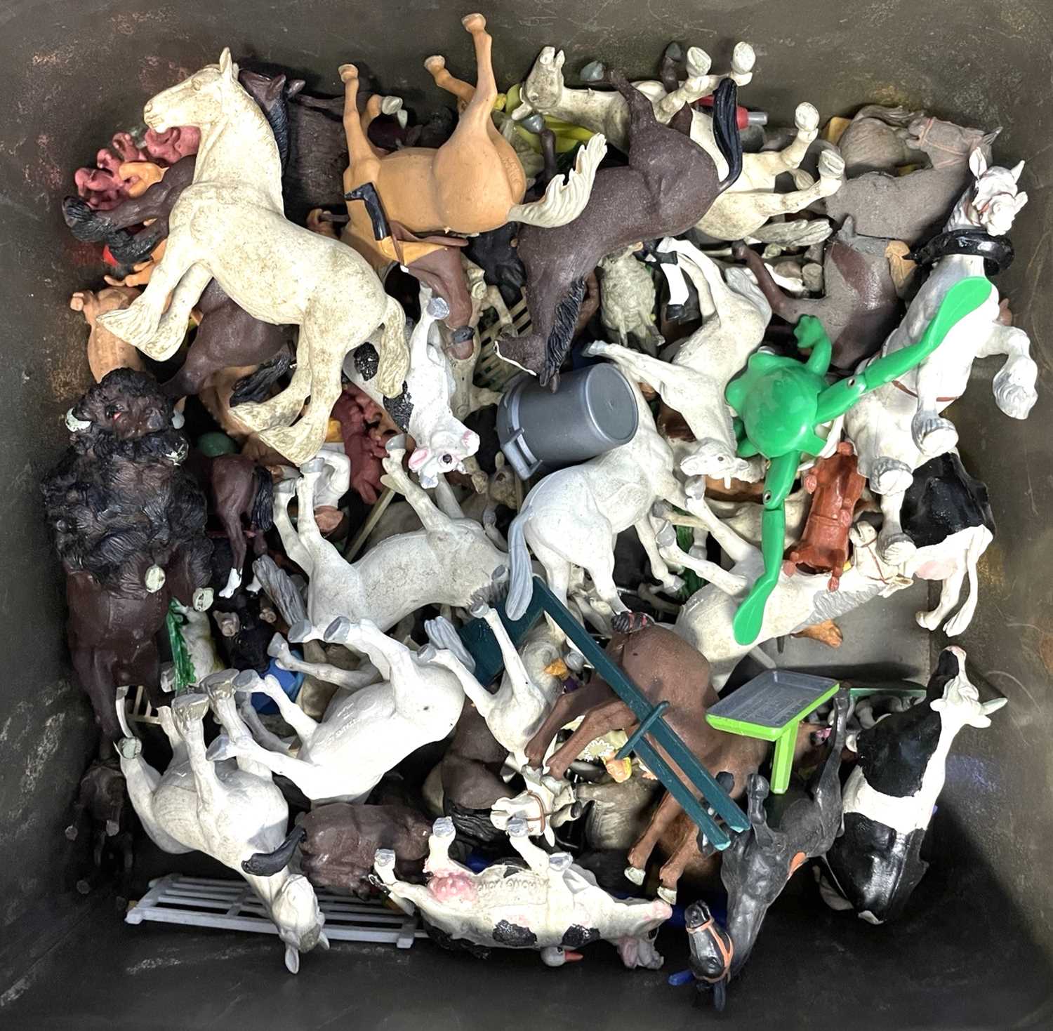 A collection of plastic farm animals, mostly Britains