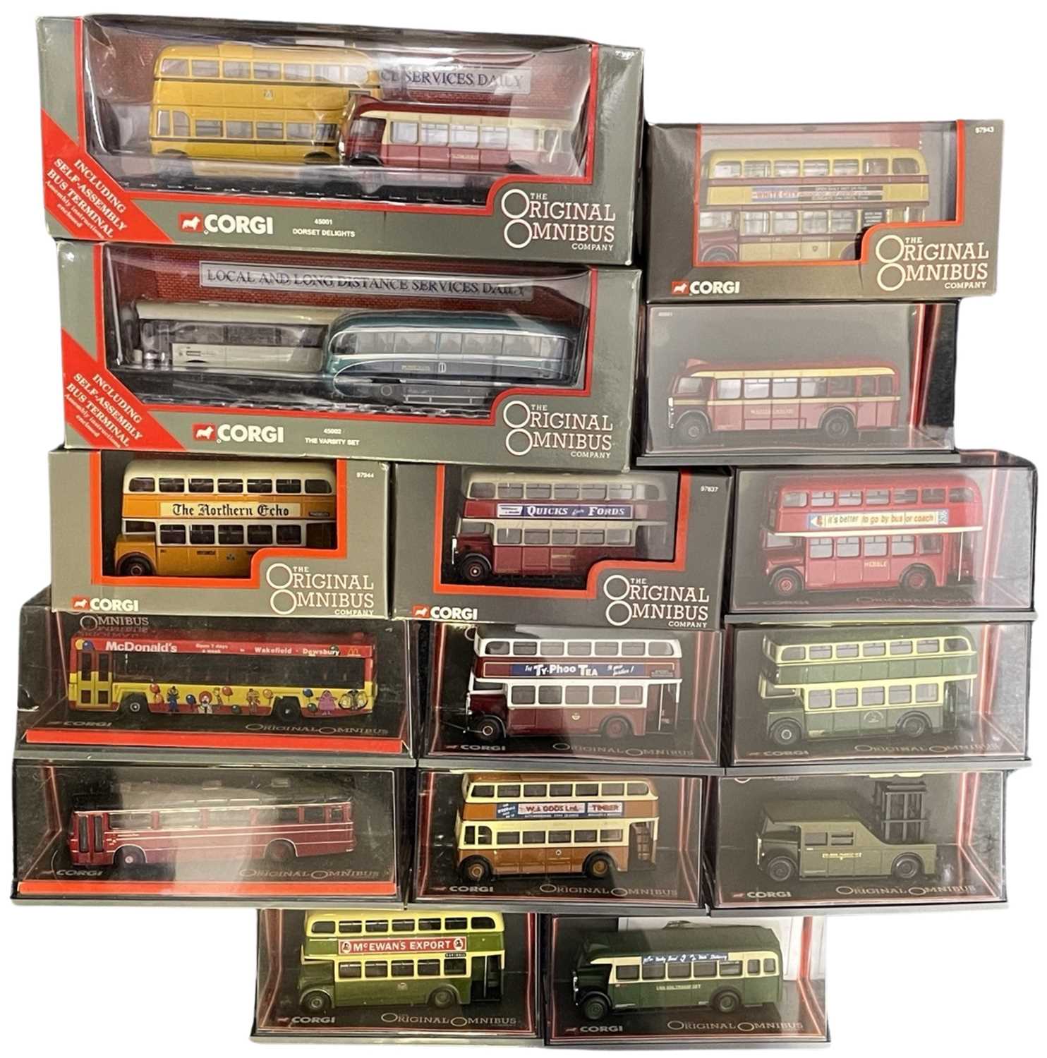 A collection of various cased Corgi Omnibus buses