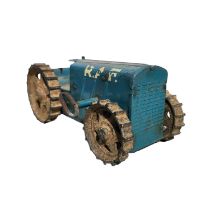 A Triang pressed steel clockwork tractor with key