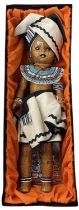 A boxed AboSisi Sisters of Africa doll, 'Xhosa Woman' handmade from newspapers in traditional tribal