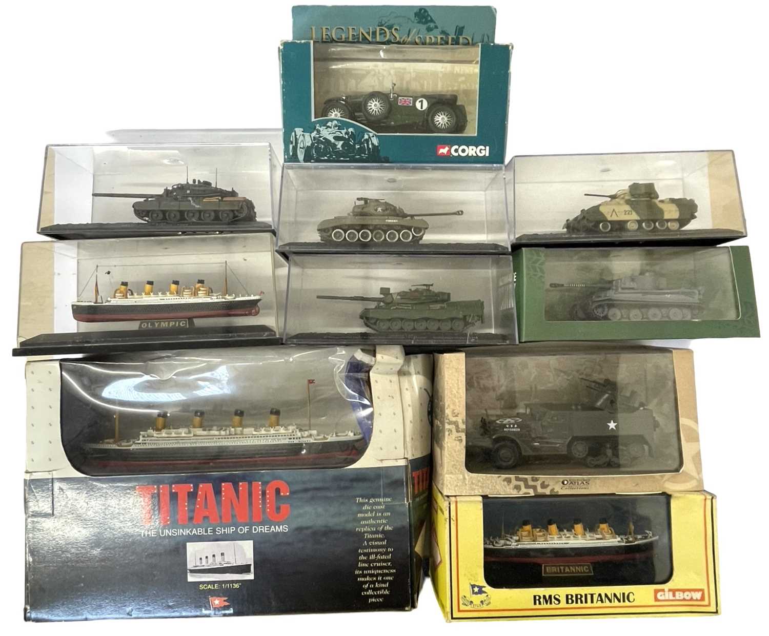 A collection of various cased die-cast tanks and ships